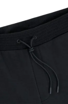 Relaxed-fit tracksuit bottoms with tonal artwork